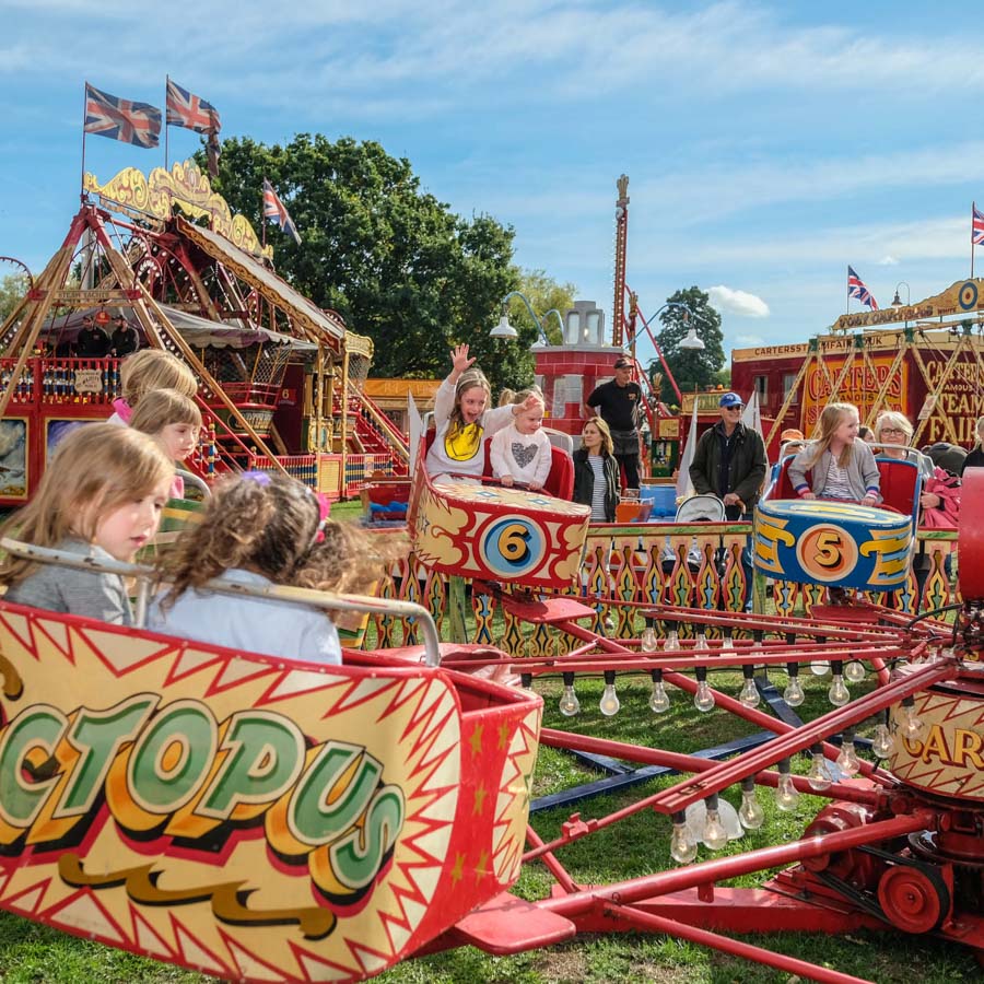 A child winning a soft toy prize at the hook a duck fairground game