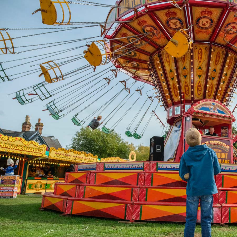 A child winning a soft toy prize at the hook a duck fairground game