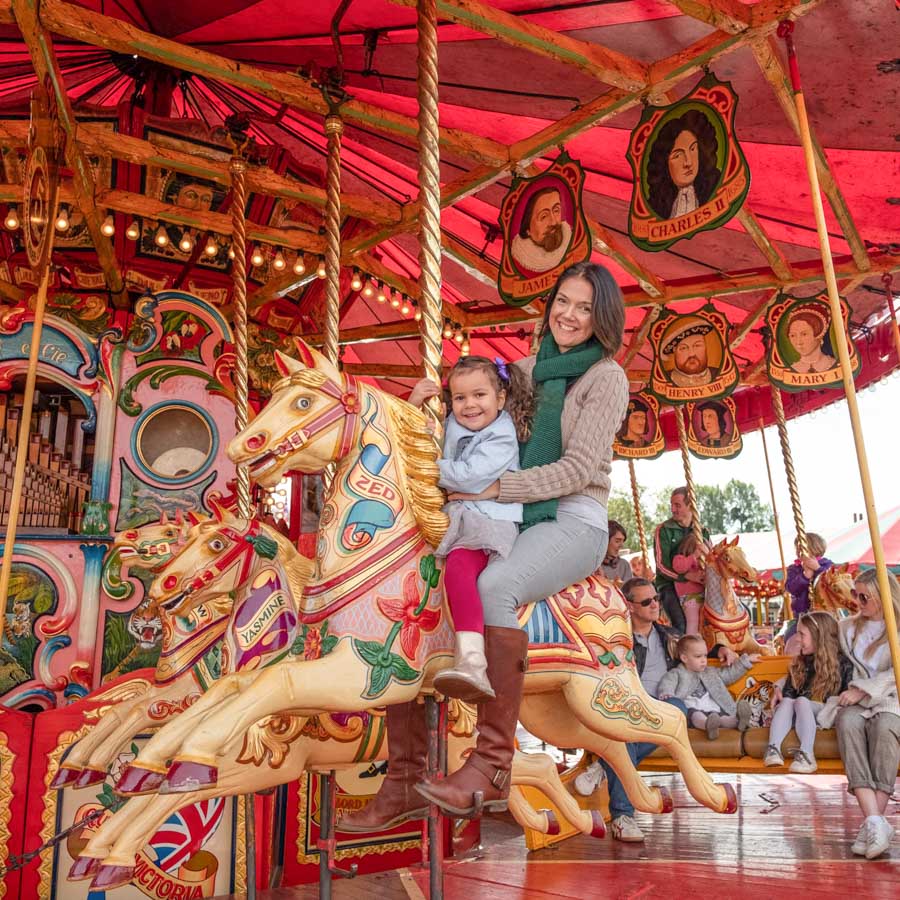 A child winning a soft toy prize at the hook a duck fairground game