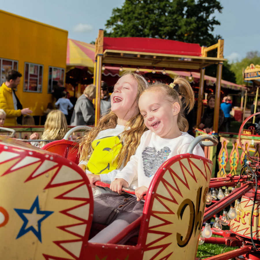 A child winning a soft toy prize at the hook a duck fairground game