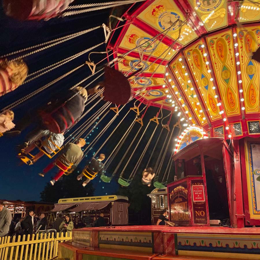 A child winning a soft toy prize at the hook a duck fairground game