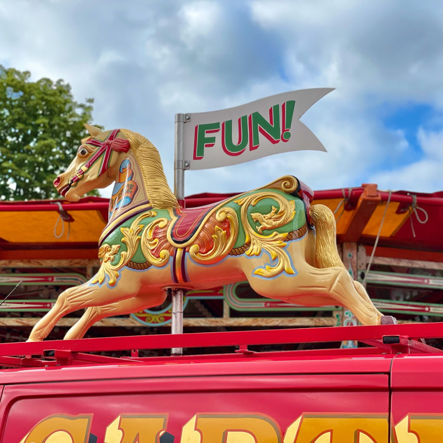 A child winning a soft toy prize at the hook a duck fairground game