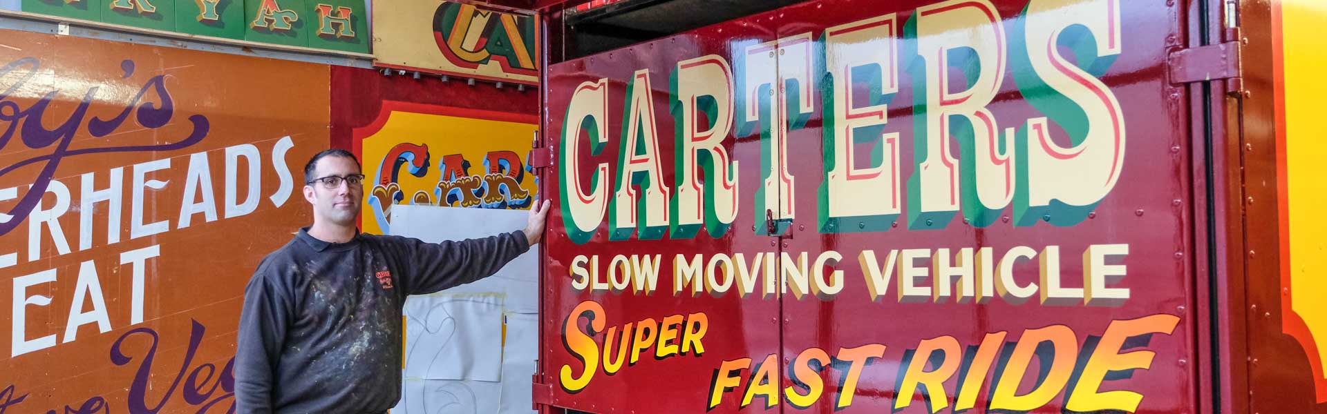 Joby Carter with fancy letters painted on a truck